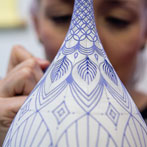 Rhian Malin decorating a mandala bottle in her workshop 2019